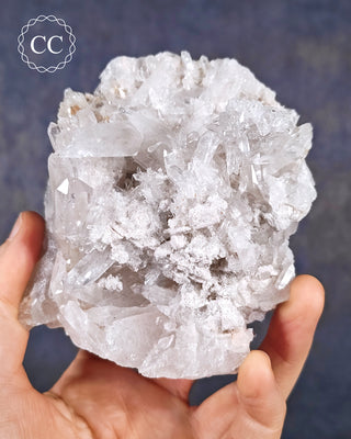 A hand holding a Clear Quartz Cluster from Brazil 