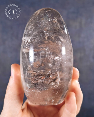 A hand holding a polished Clear Quartz Freeform from Madagascar