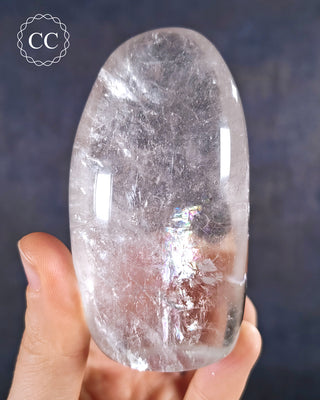 A hand holding a polished Clear Quartz Freeform from Madagascar