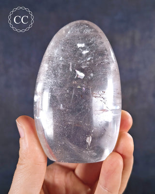 A hand holding a polished Clear Quartz Freeform from Madagascar