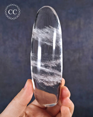 A hand holding a polished Clear Quartz Freeform from Madagascar