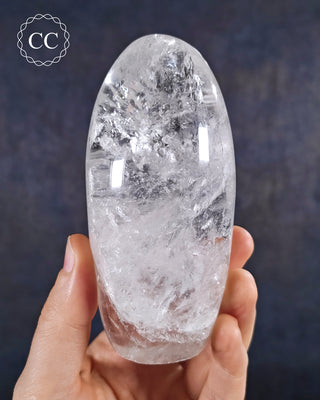 A hand holding a polished Clear Quartz Freeform from Madagascar