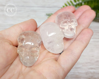 Clear Quartz Skull crystal carvings in hand