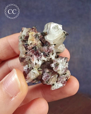 A hand holding a Crystalline Moonstone specimen from the Pili Mine in Chihuahua, Mexico. 