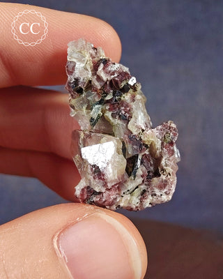 A hand holding a Crystalline Moonstone specimen from the Pili Mine in Chihuahua, Mexico. 