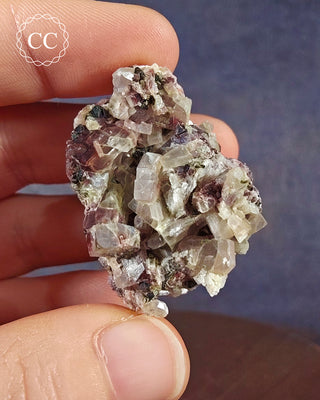 A hand holding a Crystalline Moonstone specimen from the Pili Mine in Chihuahua, Mexico. 