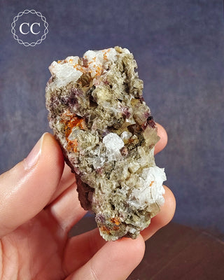 A hand holding a Crystalline Moonstone specimen from the Pili Mine in Chihuahua, Mexico. 