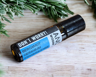 Don't Worry Essential Oil Rollerball perfume on wooden table
