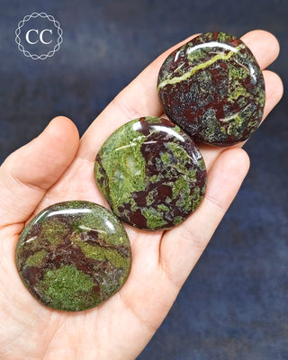 Dragons Blood Jasper Palm Stones in hand