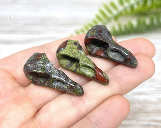 Dragons Blood Jasper Raven Skulls in hand