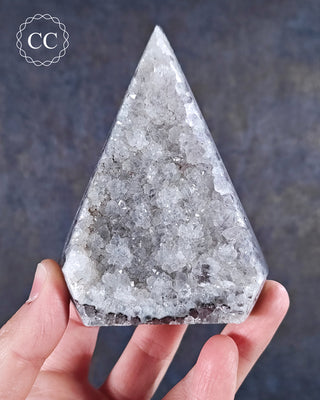 A hand holding a Druzy Agate Freeform