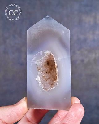 A Druzy Agate Tower displayed in fingers