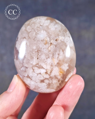 A hand holding a Flower Agate Chunky Palmstone from Madagascar