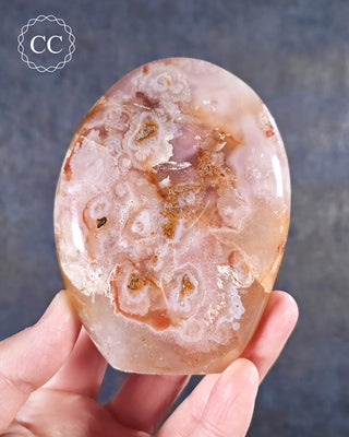 A hand holding a Flower Agate Freeform from Madgascar 