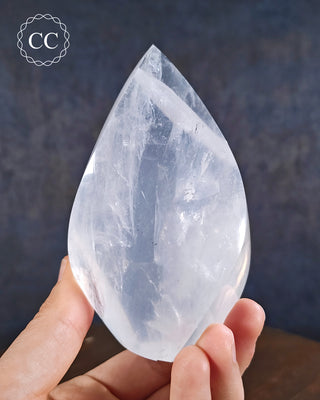 Girasol Quartz Flame in hand on blue background