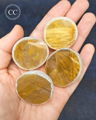 A hand holding 4 Golden Healer Dragon Eggs from Madagascar
