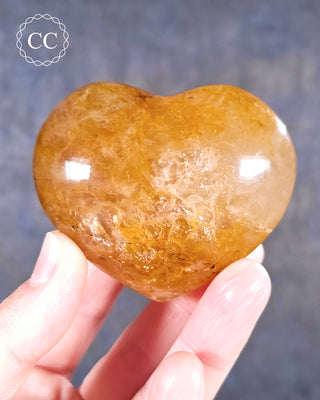 A hand holding a Golden Healer Heart from Madagascar