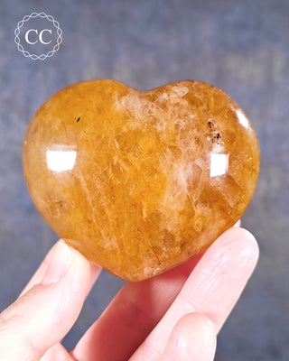 A hand holding a Golden Healer Heart from Madagascar
