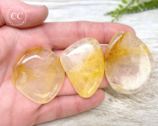 Golden Healer Flat Palm Stones in hand