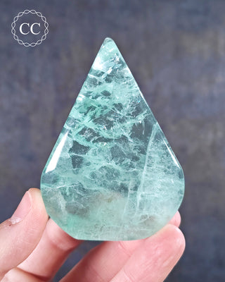 A hand holding a Green Fluorite Freeform 