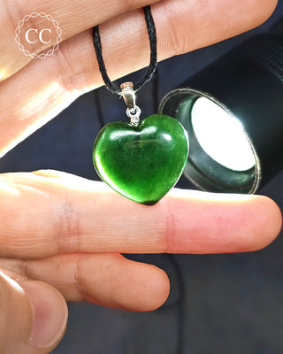 Greenland Jade Heart Pendant on a cord in a hand