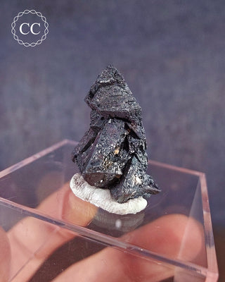 A rare formation of Hematite after Magnetite from the famous Payún Matrú volcanic field in Mendoza, Argentina on a clear display box