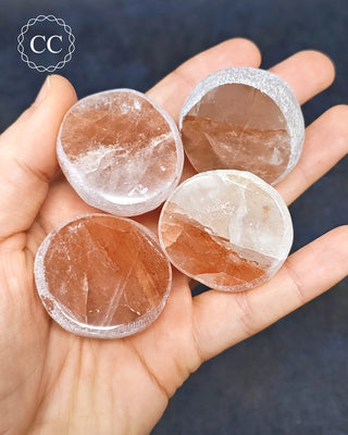 A hand holding 4 Hematoid Quartz Dragon Eggs from Madagascar