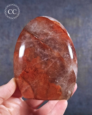 A hand holding a Hematoid Quartz - Fire Quartz Freeform from Madagascar