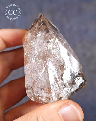 A hand holding a Herkimer Diamond from New York, USA