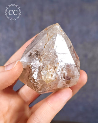 A hand holding a Herkimer Diamond from New York, USA