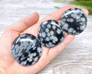Snowflake Obsidian Palm Stones in hand
