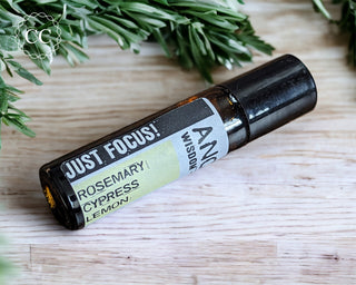 Just Focus Essential Oil Rollerball perfume on wooden table