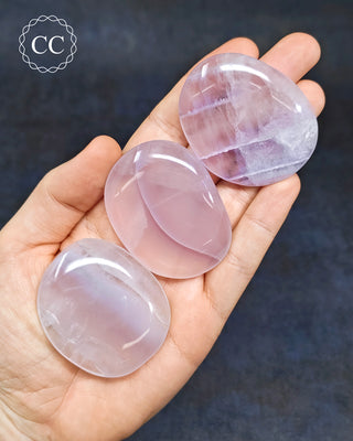 Lavender Fluorite Palm Stones in hand