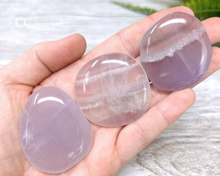 Lavender Fluorite Palm Stones in hand