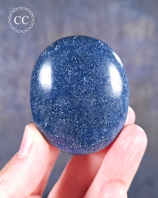 A hand holding a Lazulite Chunky Palmstone from Madagascar