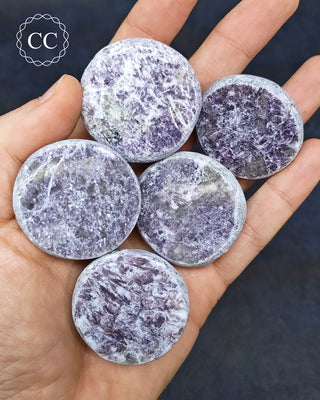 A hand holding 5 Lepidolite Dragon Eggs from Madagascar