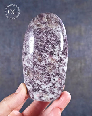A hand holding a Lepidolite Freeform from Madagascar