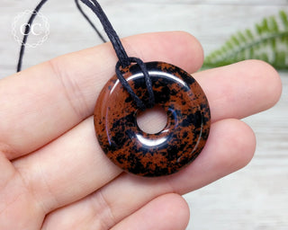 Mahogany Obsidian Donut Necklace in hand