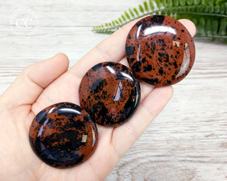 Mahogany Obsidian Palmstones in hand