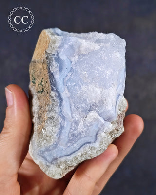 Natural Blue Agate/Blue Chalcedony specimen from Malawi, shown in a hand.