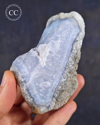 Natural Blue Agate/Blue Chalcedony specimen from Malawi, shown in a hand.