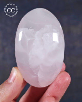 A hand holding a Mangano Calcite Chunky Palmstone from Pakistan 
