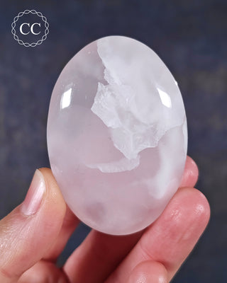 A hand holding a Mangano Calcite Chunky Palmstone from Pakistan 