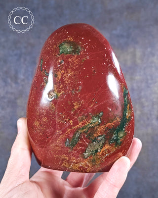 A hand holding an Ocean Jasper freeform from Madagascar