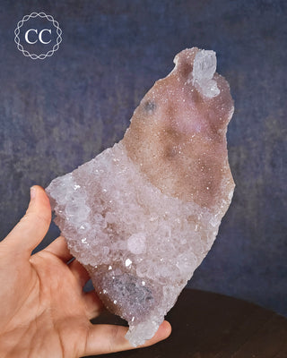 A hand holding a Pastel Flower Amethyst Specimen 
