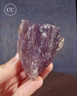 A hand holding a Phospherescent Fluorite specimen from the El Potosi Mine in Mexico