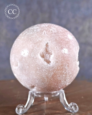 A pink Amethyst Sphere from Brazil with crystal vug