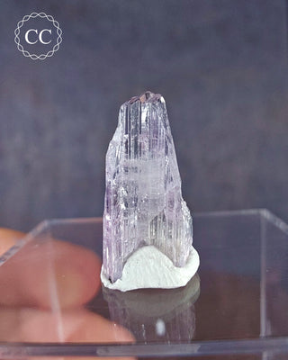 A Pink Tanzanite crystal from Tanzania on a  clear display box