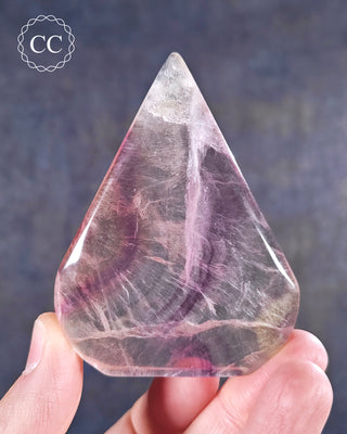 A hand holding a Rainbow Fluorite Freeform 