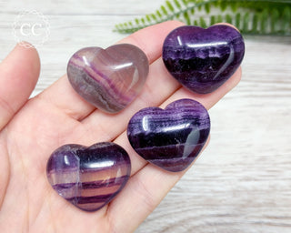 Rainbow Fluorite Heart crystals in hand